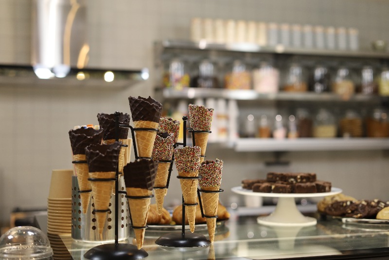 display case with cakes and desserts in